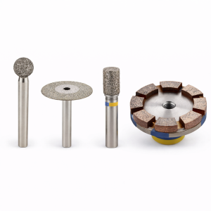 diamond tools for restoration including grinding bits polishing discs and segmented wheel on white background